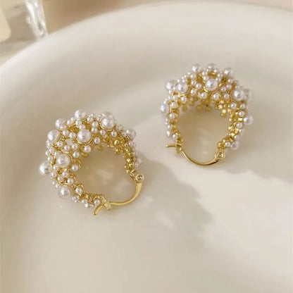 Gold-colour copper flower basket earrings with small rice-shaped bead inlay detail.