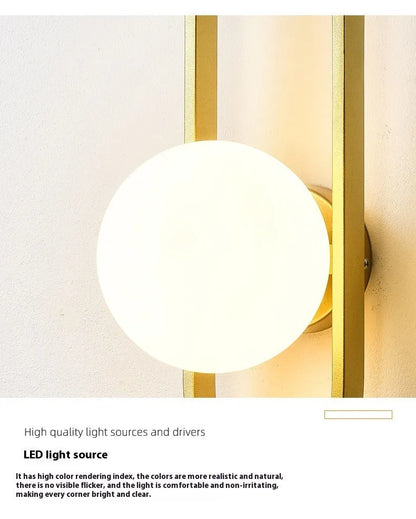 Minimalist wall lamp in black or gold finish with glass shade and 12W tri-colour LED lighting