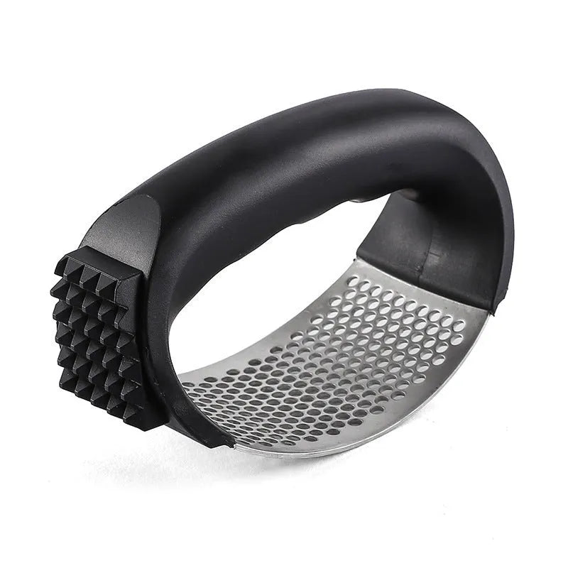 Stainless steel garlic press with coloured handles in a modern design, shown on a kitchen counter.