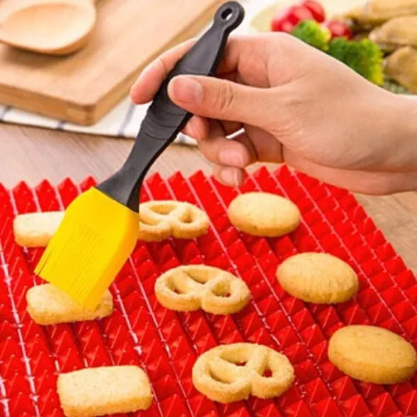 Red silicone pyramid grid cooking mat on a kitchen counter