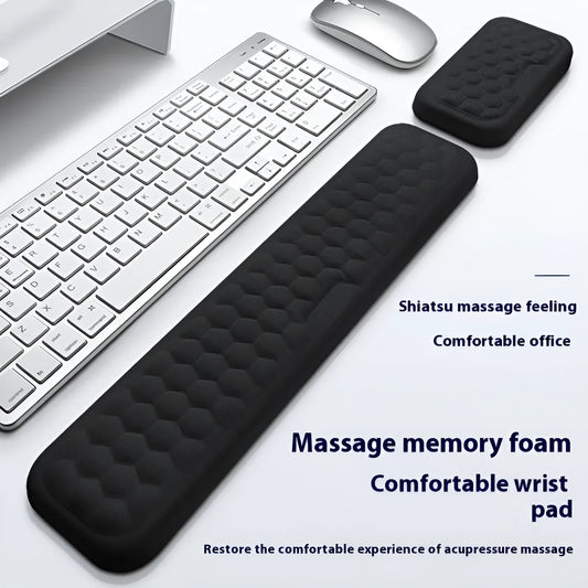 Black and grey memory foam mouse wrist rests with cloth and leather-style covers on a desk.