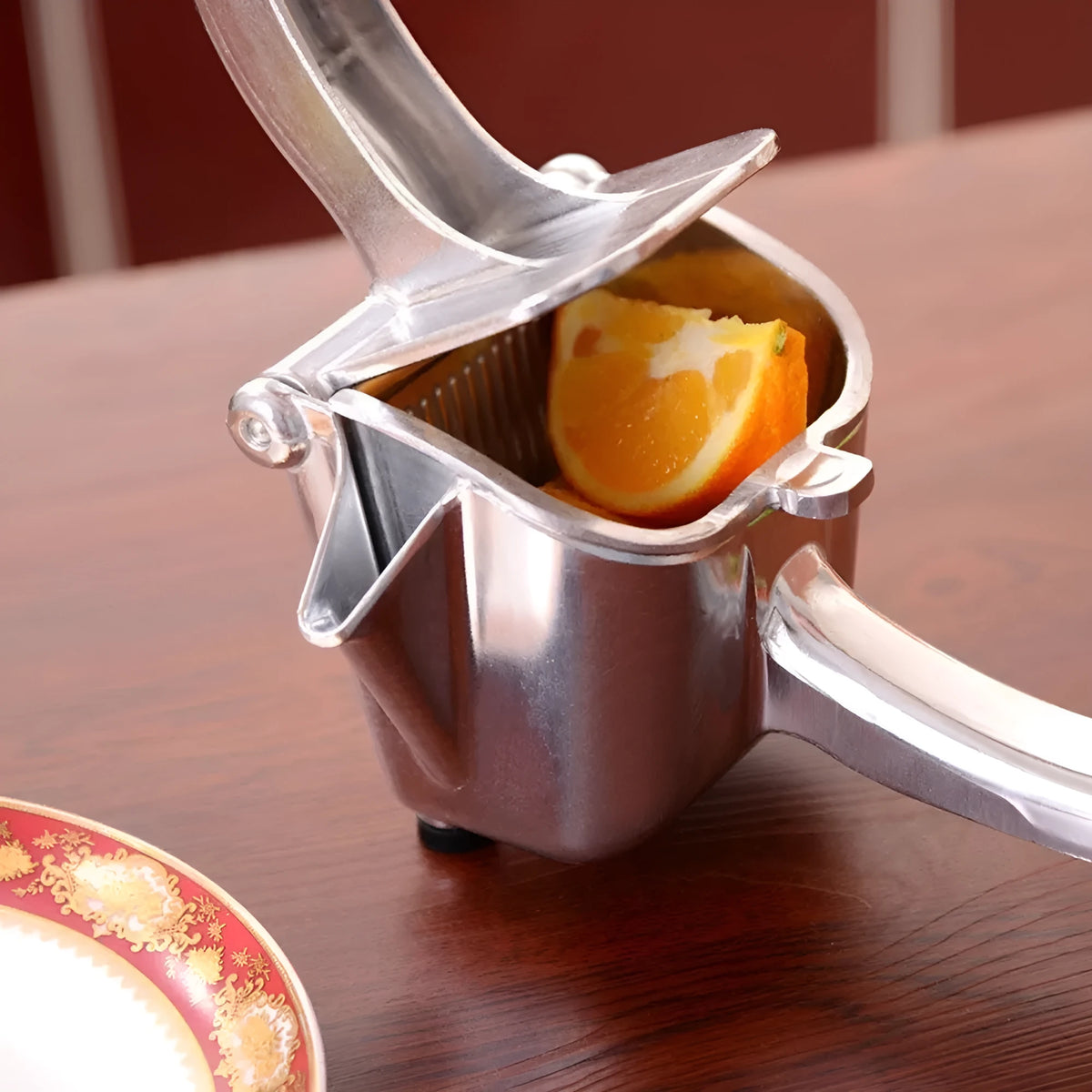 Silver heavy duty aluminium and steel lemon squeezer with large bowl and long handle.