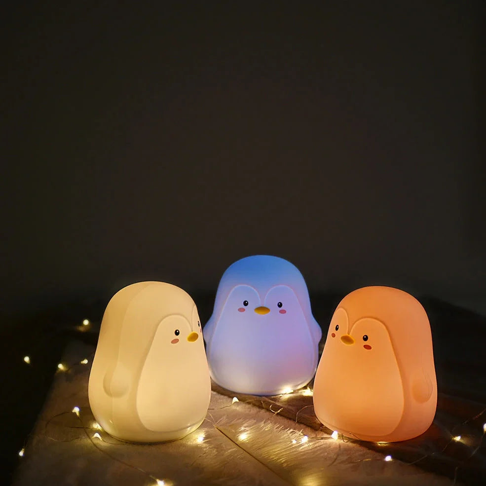 Penguin-shaped night light with soft white LED illumination and USB charging port