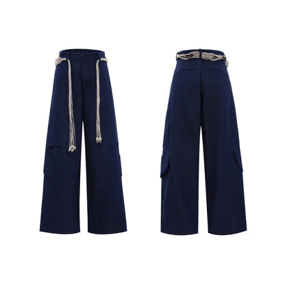 Men's dark blue straight-leg cotton jeans with 3D cutting, belt stitching, and decorative tassel on a hanger