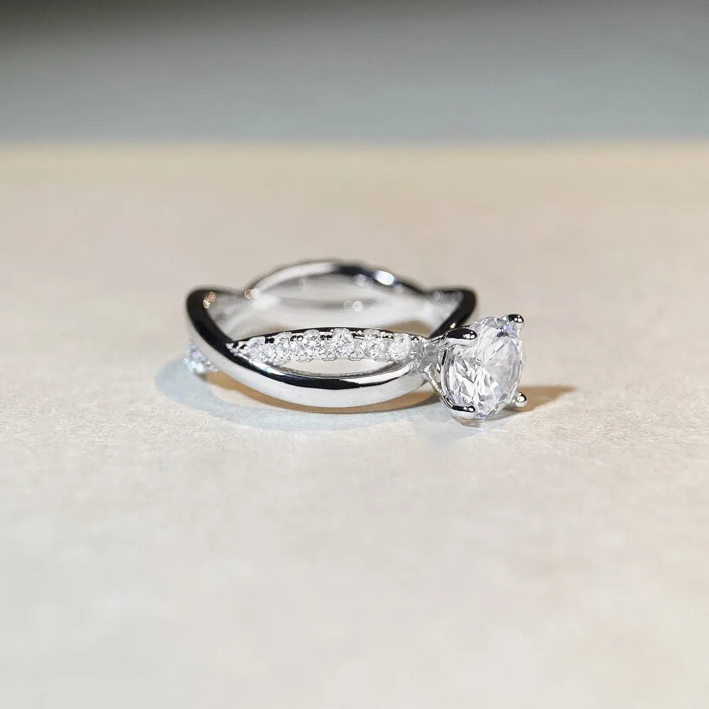 Geometric silver ring with 1 karat moissanite centre stone in four-claw setting and twisted arm band design