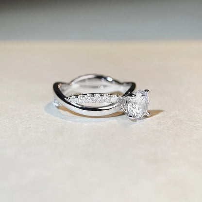 Geometric silver ring with 1 karat moissanite centre stone in four-claw setting and twisted arm band design