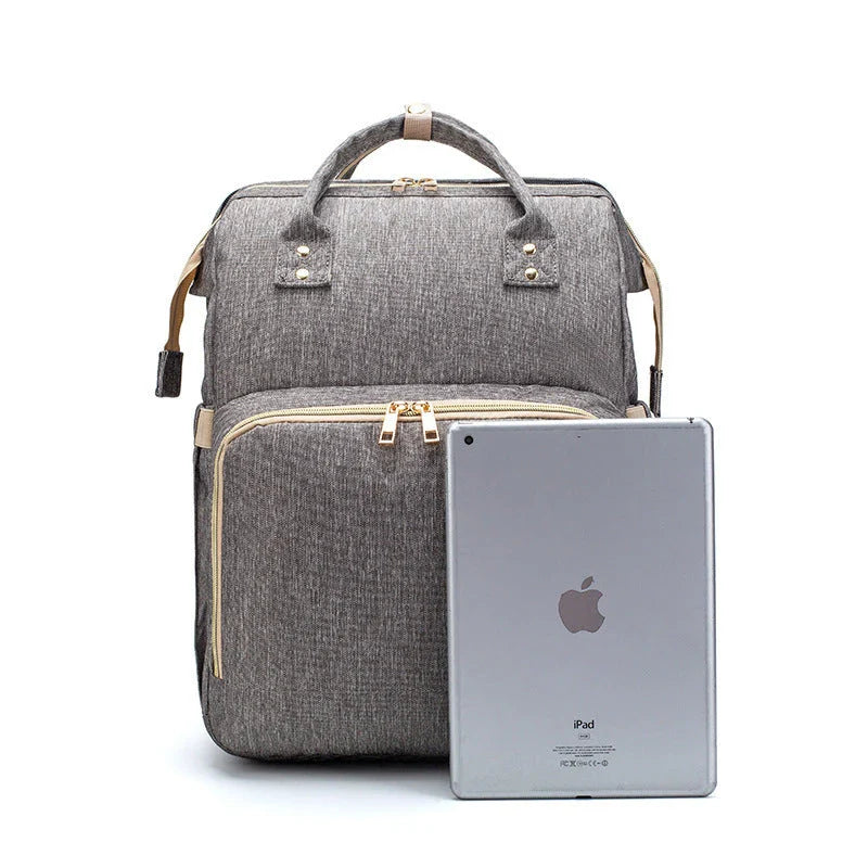 Versatile baby changing backpack with USB charging port and folding portable bed
