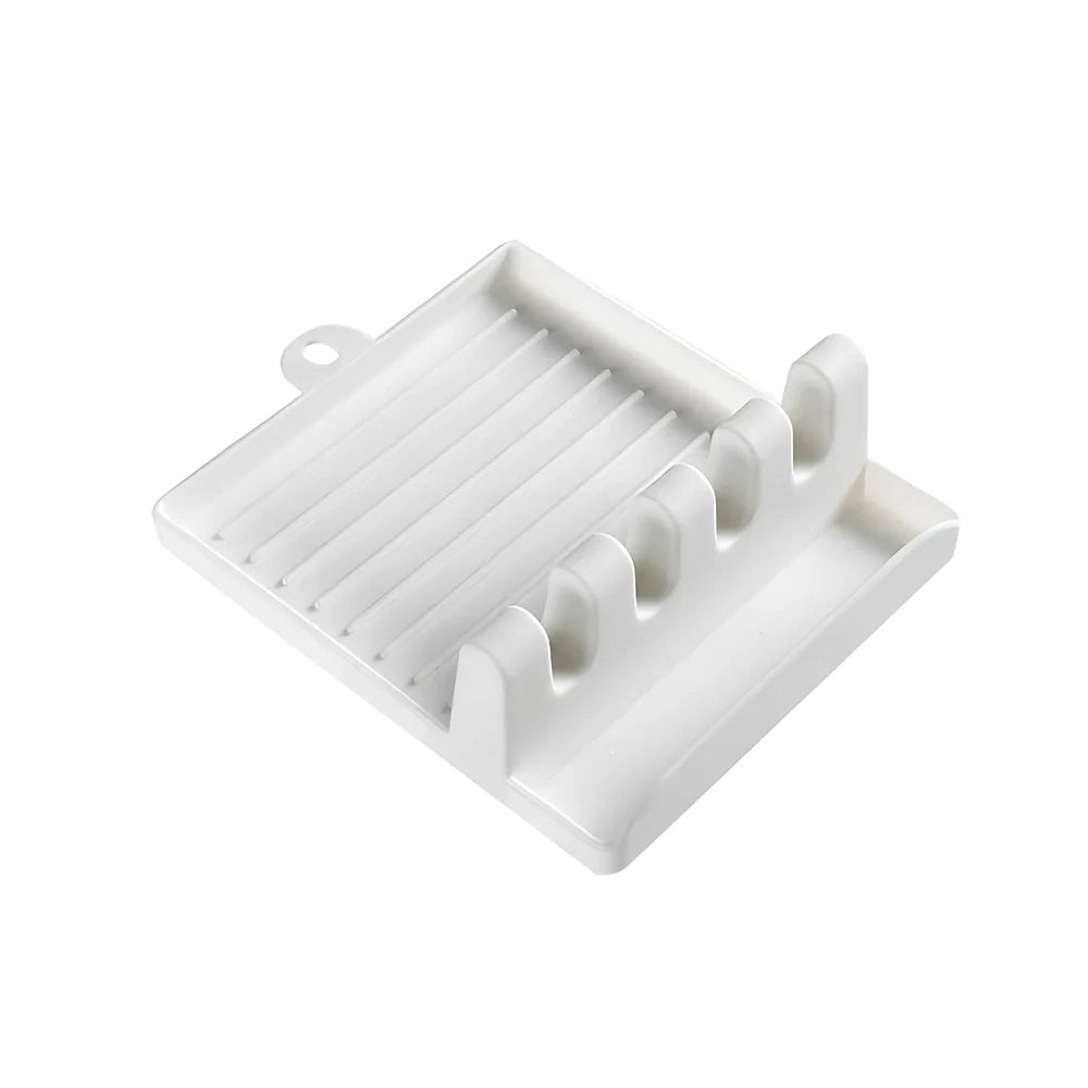 Green silicone spatula holder with four slots for kitchen utensils on countertop