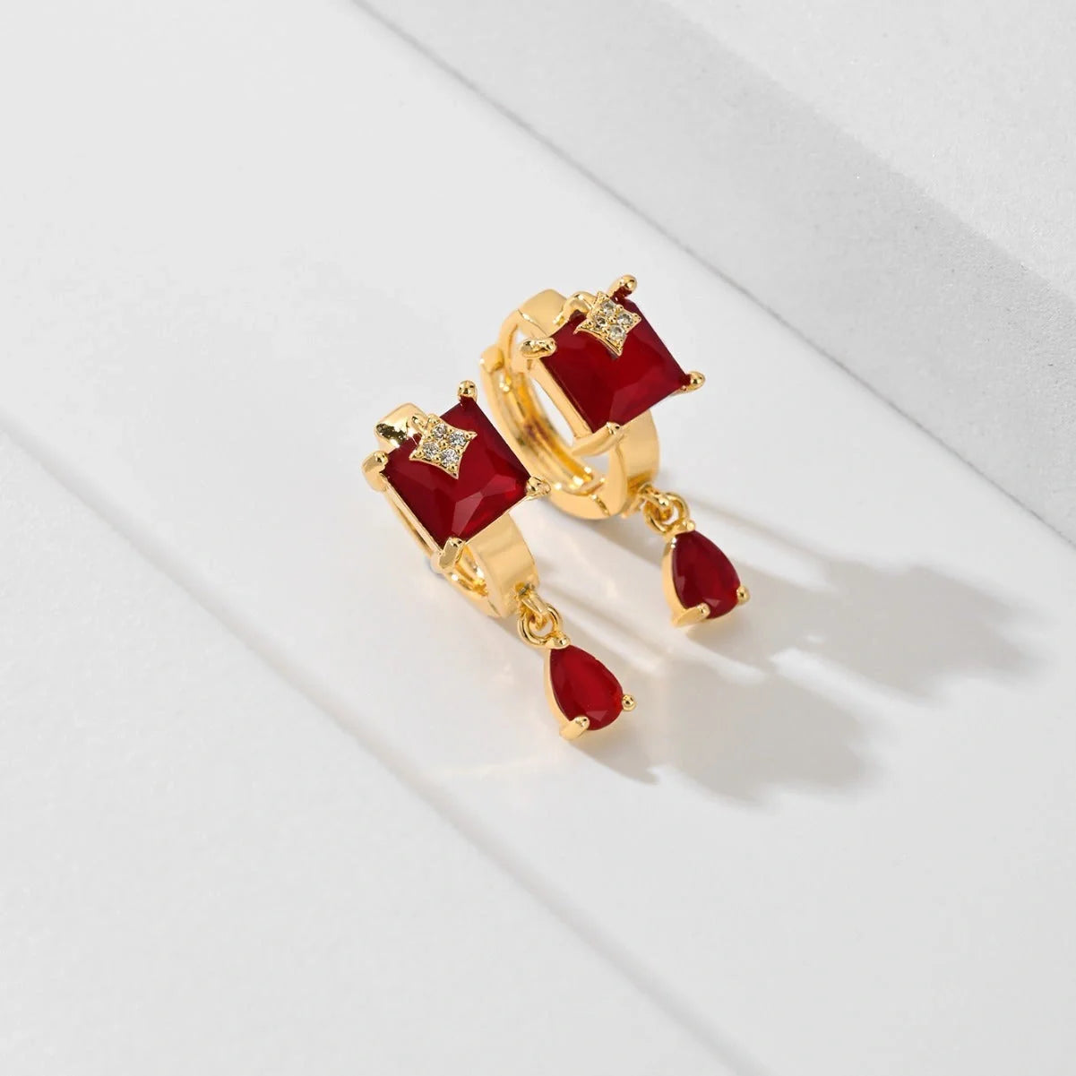 Trendy copper-plated gold fashion earrings with water droplet design in multiple colors.