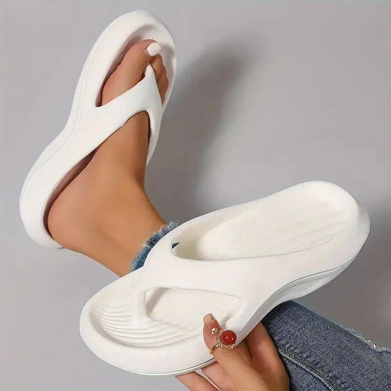 Women's black thick-soled EVA flip-flops with a non-slip pattern on the sole.