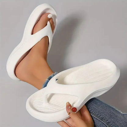 Women's black thick-soled EVA flip-flops with a non-slip pattern on the sole.