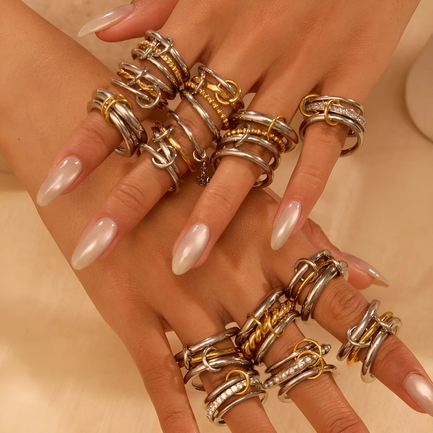 Stacked stainless steel rings with 18K gold plating in three colour variations, exaggerated hand jewellery designs