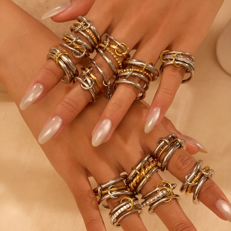Stacked colour matching stainless steel ring set with 18K gold plating, featuring exaggerated personalised hand jewellery designs in three distinct colour variations for versatile styling.