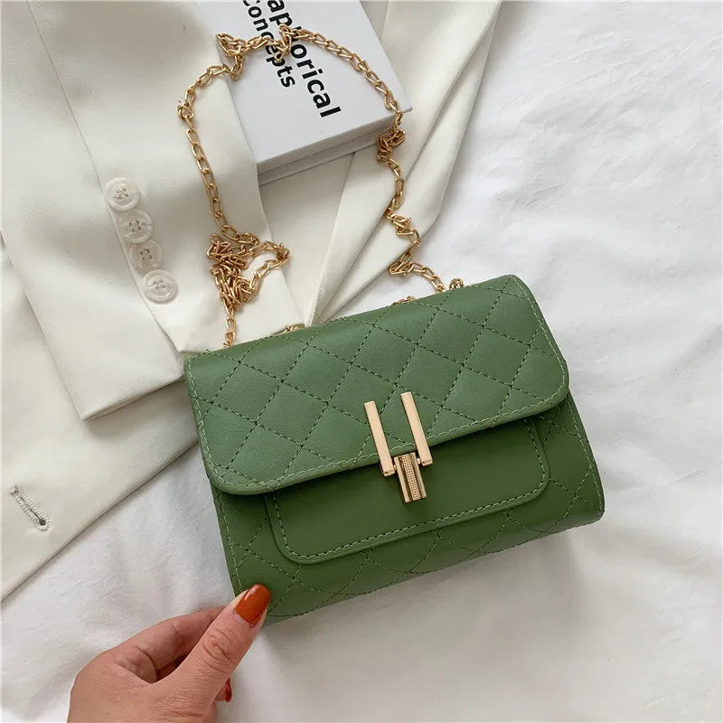 Women's solid colour PU leather crossbody bag with diamond lattice chain strap in black, green, or white.