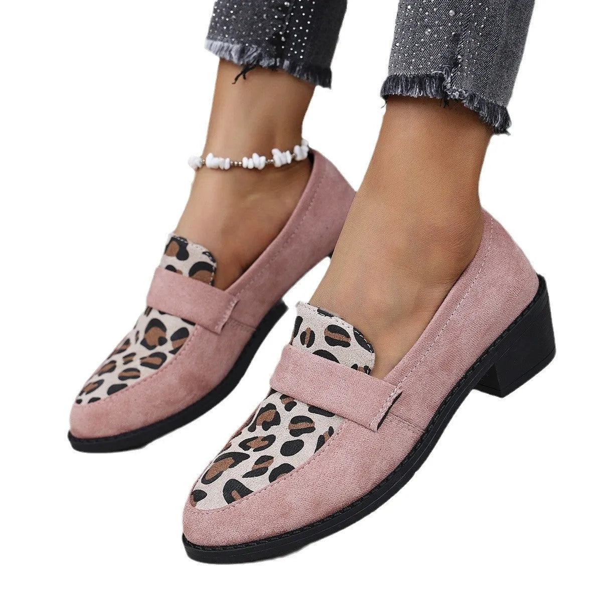 Leopard print slip-on suede pump shoe with chunky mid heel and pointed toe on a rubber sole.