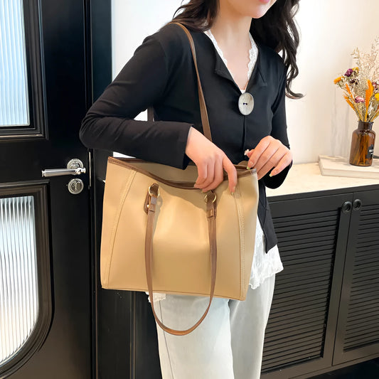 Horizontal square tote bag in black with contrast colour accents showing internal mobile phone pocket and document compartment