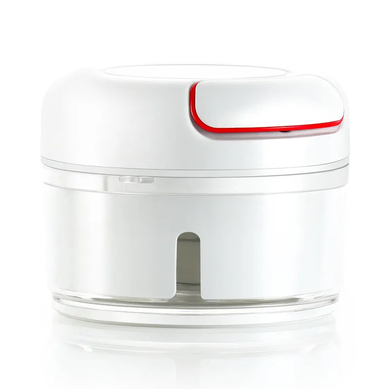 White manual food chopper with stainless steel blades on a kitchen countertop.