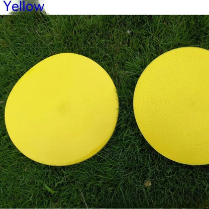 Soft yellow TPE football landmark pad disc on grass, 23 cm diameter.