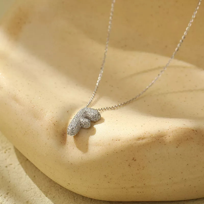 Stainless steel initial pendant necklace with zircon accents, personalized with your choice of letter.