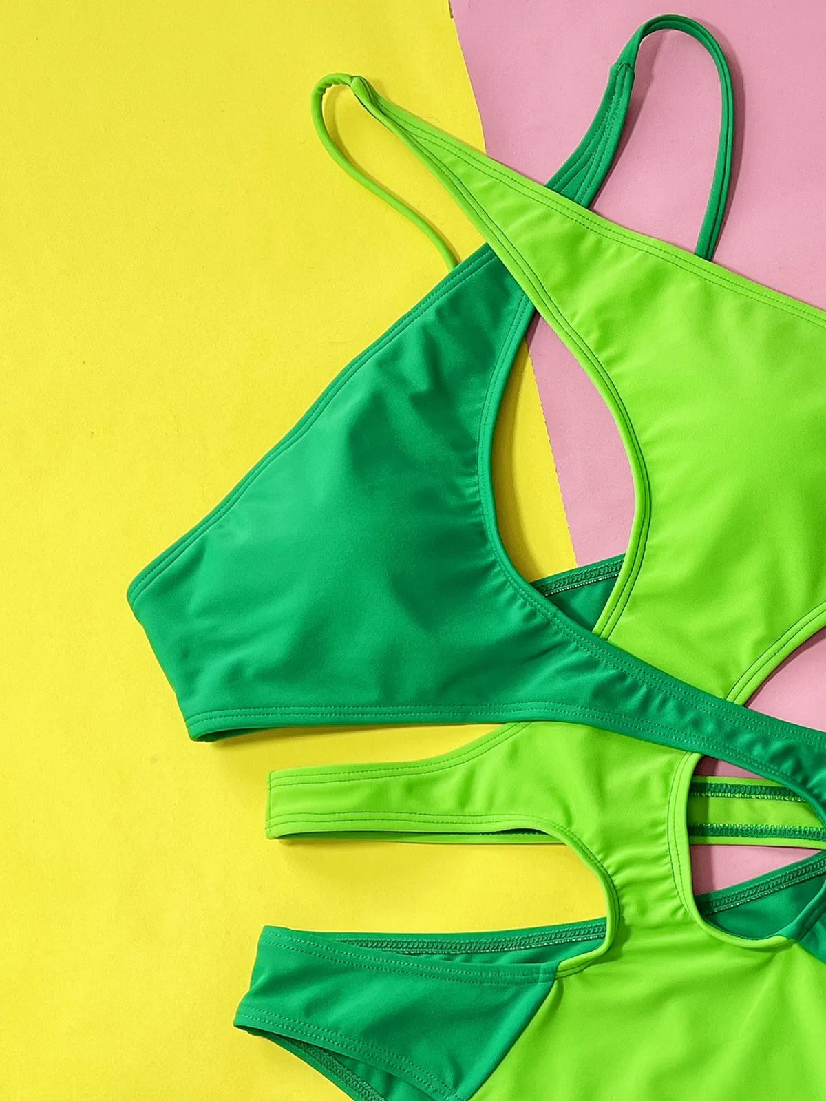 Women's solid green one-piece swimsuit with hollow contrast detail.