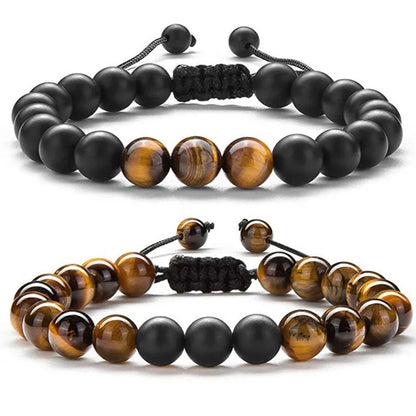 Tiger Eye and black agate geometric couple bracelets laid out as a matching set.