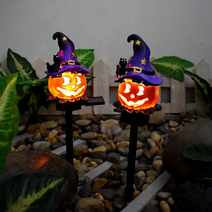Solar-powered Halloween pumpkin lanterns lighting up a garden at night