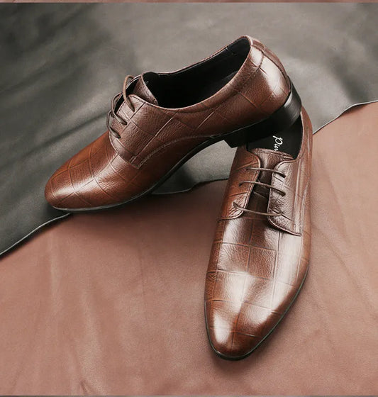 Men's black leather derby shoes with pointed toe, visible sewing details, and antiskid rubber soles