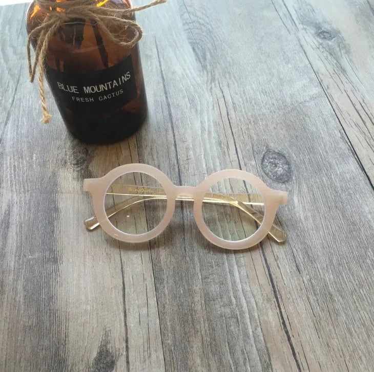 Retro round frame anti blue light glasses in various colours on a plain background