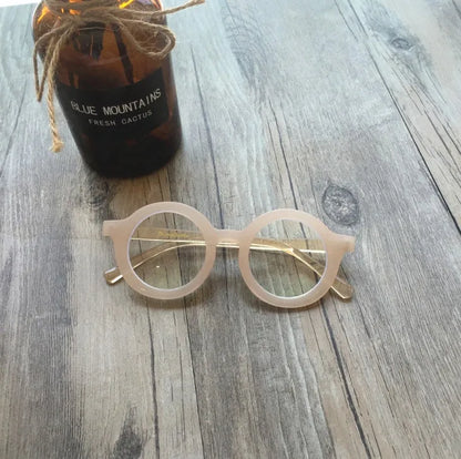 Retro round frame anti blue light glasses in various colours on a plain background