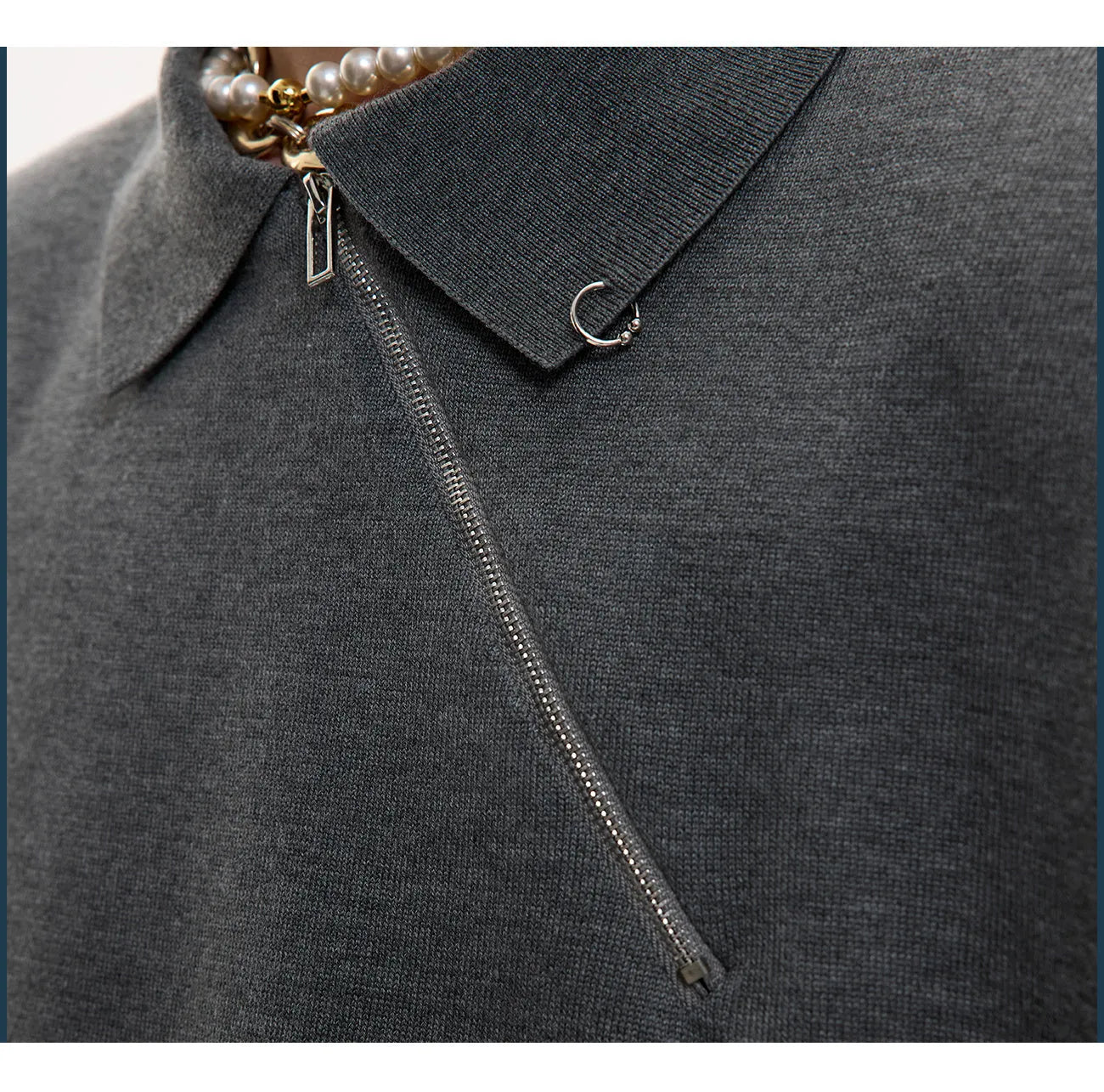 Men's slim-fit black knitted polo shirt with an oblique diagonal zipper and short sleeves.