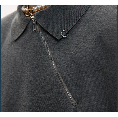 Men's slim-fit black knitted polo shirt with an oblique diagonal zipper and short sleeves.