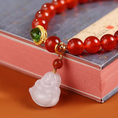 Handcrafted red agate bracelet with amber beads, jade accents, and Maitreya Buddha pendant in Chinese geometric style