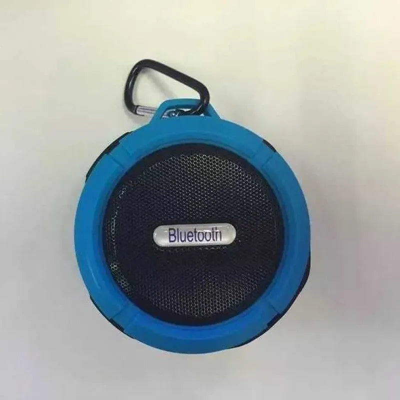 C6 portable waterproof Bluetooth speaker in multiple colours with a mounting clip attached.