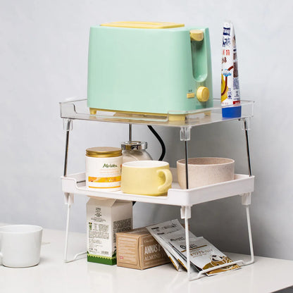 Transparent and white plastic kitchen supplies rack with multiple compartments for drawer and shelf organisation
