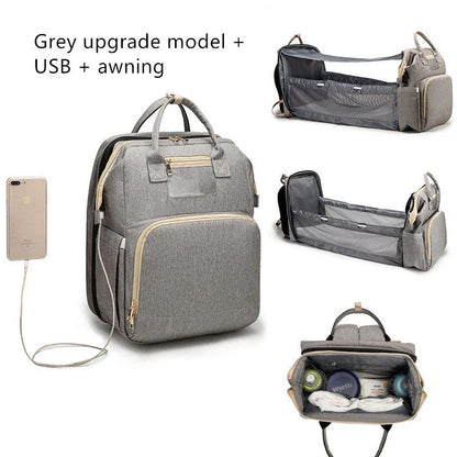 Versatile baby changing backpack with USB charging port and folding portable bed