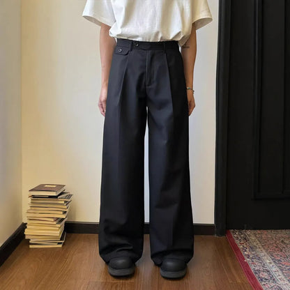 Men's brown straight-leg casual trousers with a relaxed drape and wide-leg silhouette on a hanger.