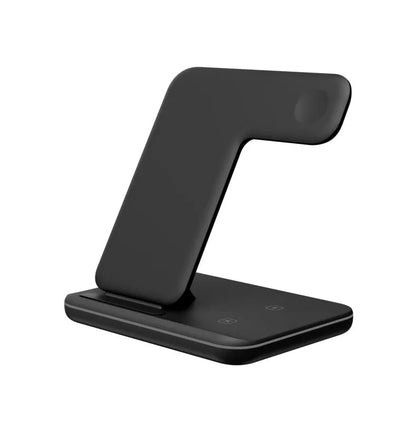 White three-in-one wireless charging stand for mobile phone, watch, and headphones on a desk.