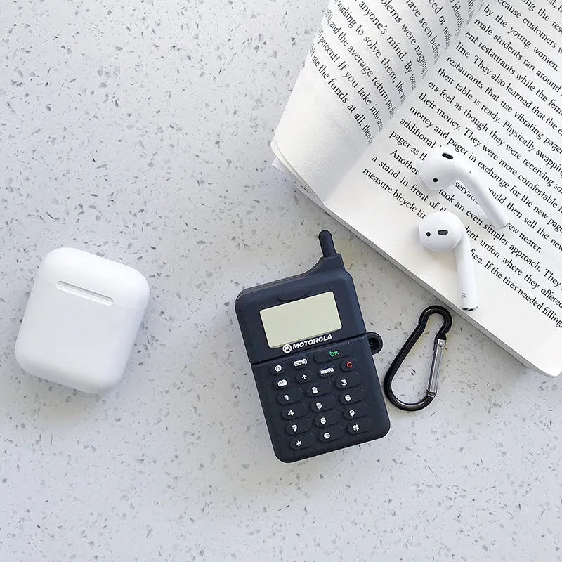 Green silicone AirPods case with a cartoon animal print, showing charging port cutout.