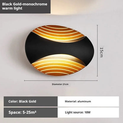 Modern aluminium wall lamp in black finish mounted beside a bed, emitting warm LED light.