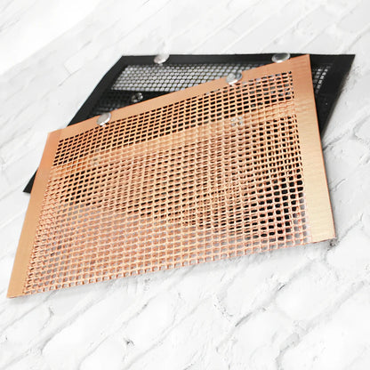 Black grill mesh bag with non-stick grid mat on barbecue, showing smoke circulation through mesh design