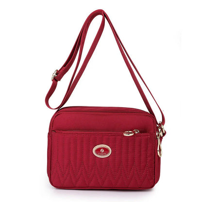 Casual women's crossbody messenger bag in nylon with polyester lining, available in multiple colors