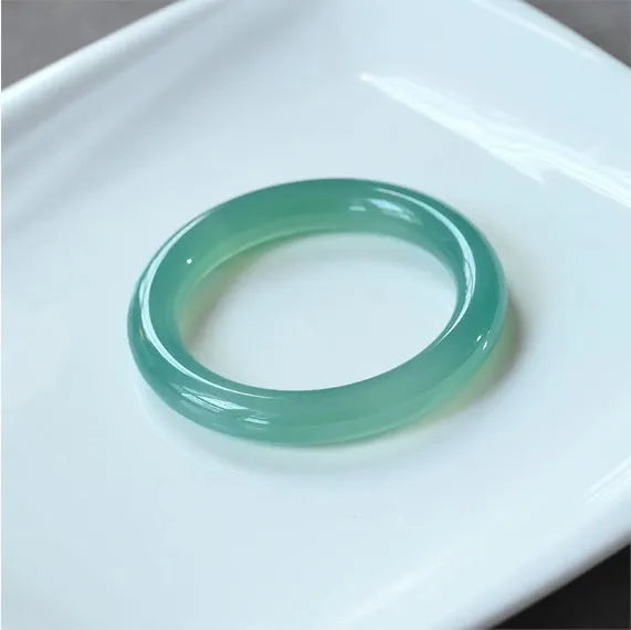 Natural agate wide tyre bracelet showing the stone's colour and the band's solid design on a wrist.
