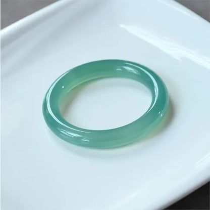 Natural agate wide tyre bracelet showing the stone's colour and the band's solid design on a wrist.