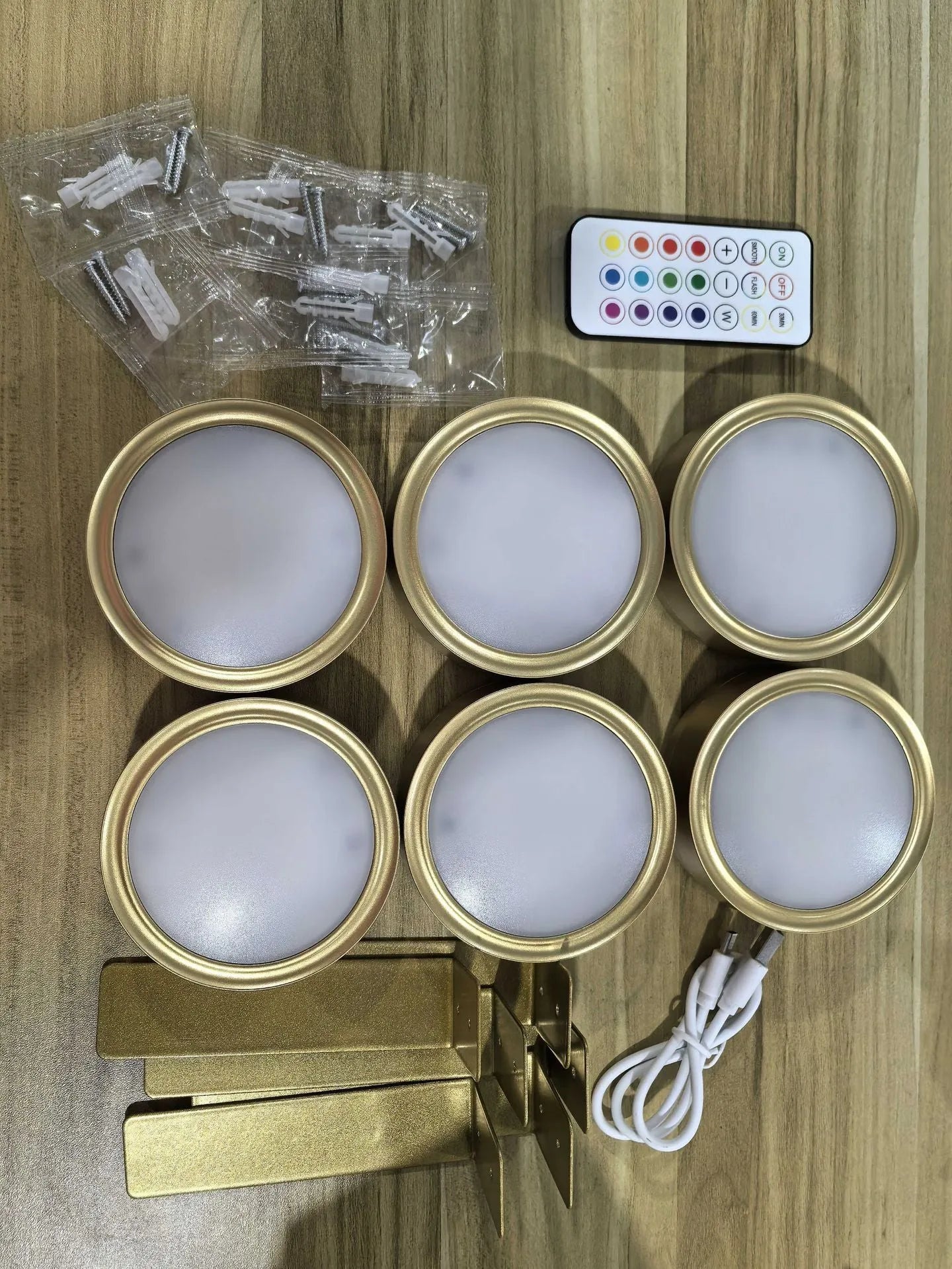 Black magnetic LED painting lamp with remote control on a white wall.