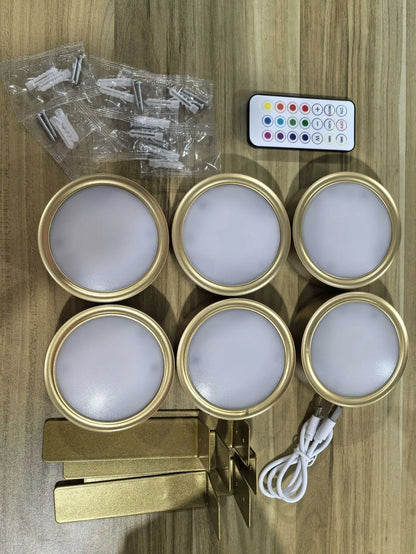 Black magnetic LED painting lamp with remote control on a white wall.