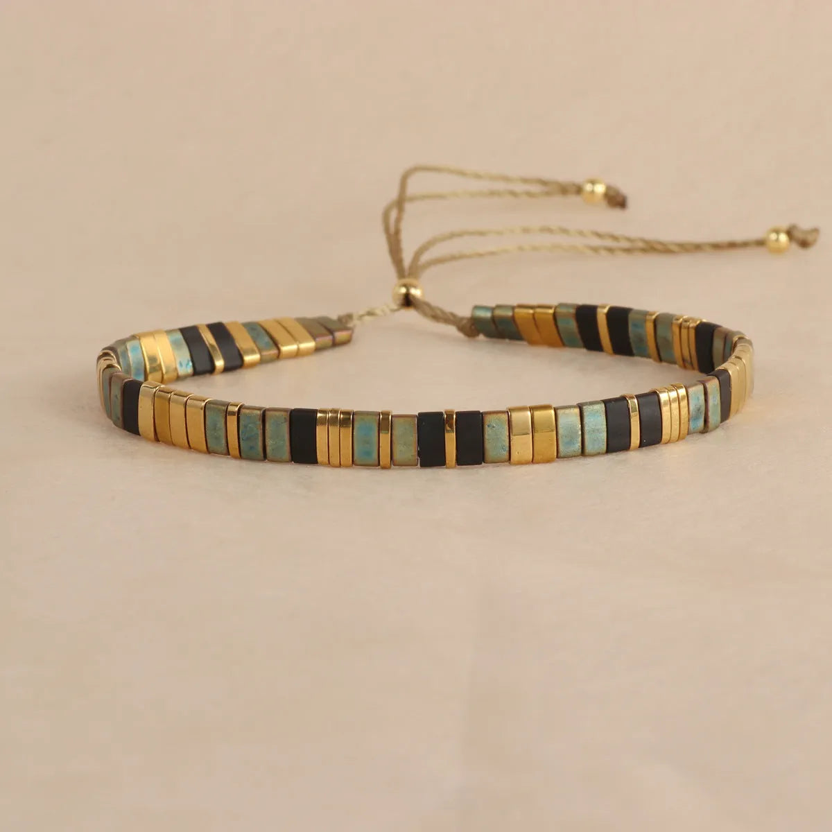Adjustable pull beads glass bracelet in geometric shapes, shown in milky white colour.