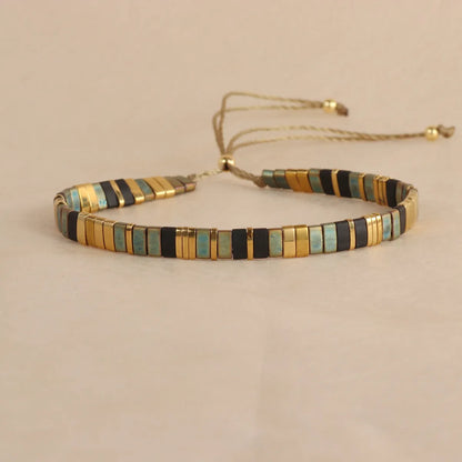 Adjustable pull beads glass bracelet in geometric shapes, shown in milky white colour.