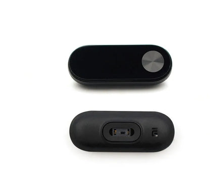 Xiaomi Mi Band 2 black fitness tracker with OLED display showing heart rate and time on adjustable wrist strap