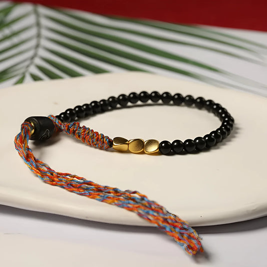 Hand-woven obsidian carrying strap showing woven texture and 4mm width