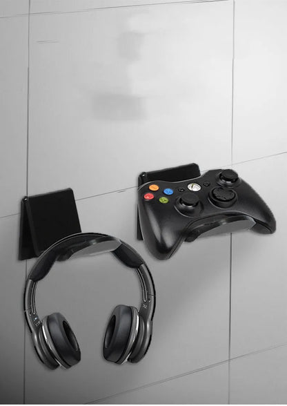 A universal black game controller mounting bracket shown installed on a wall.